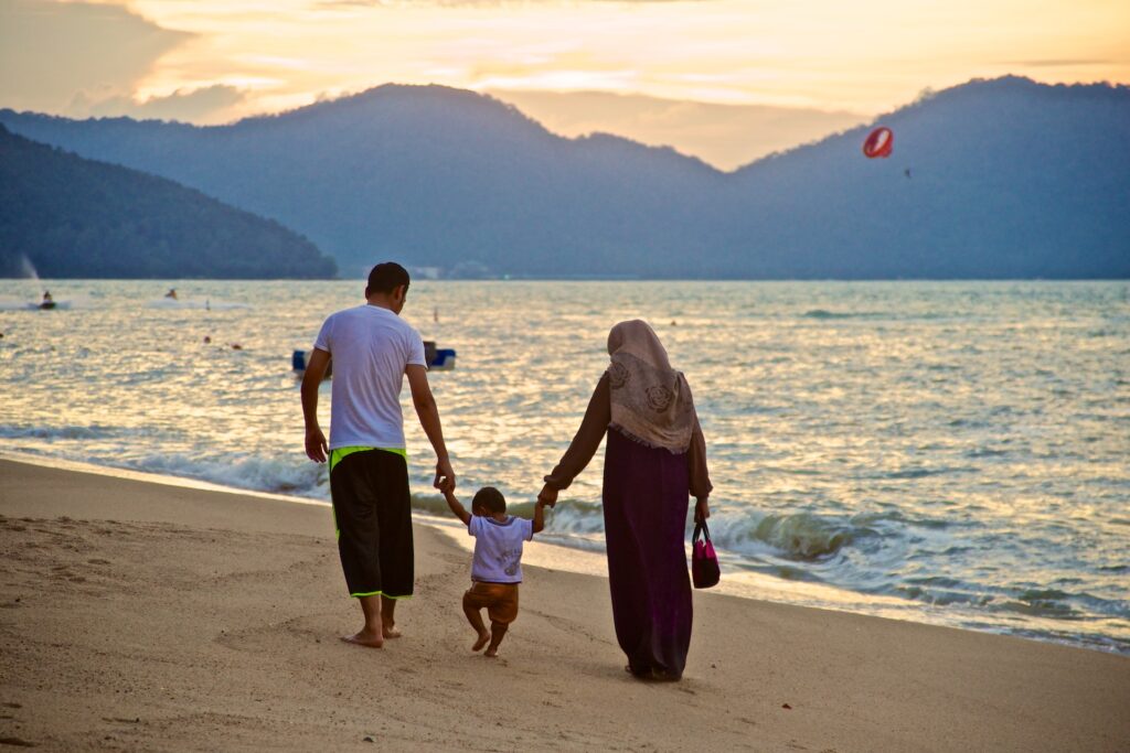 muslim wife and husband walking with their baby